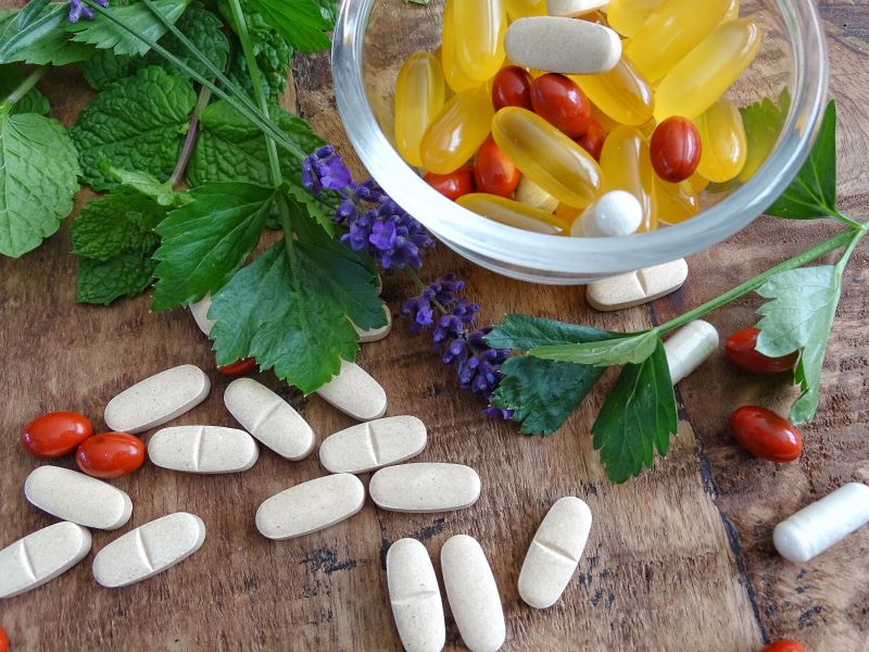 bowl with multi vitamins supplements omega