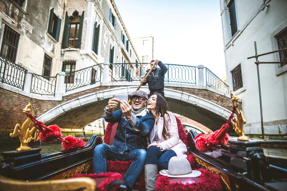 couple sailing on venetian gondola
