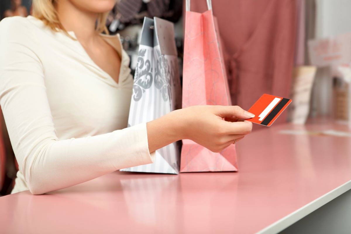 woman using shopping credit card for purchasing products in the store