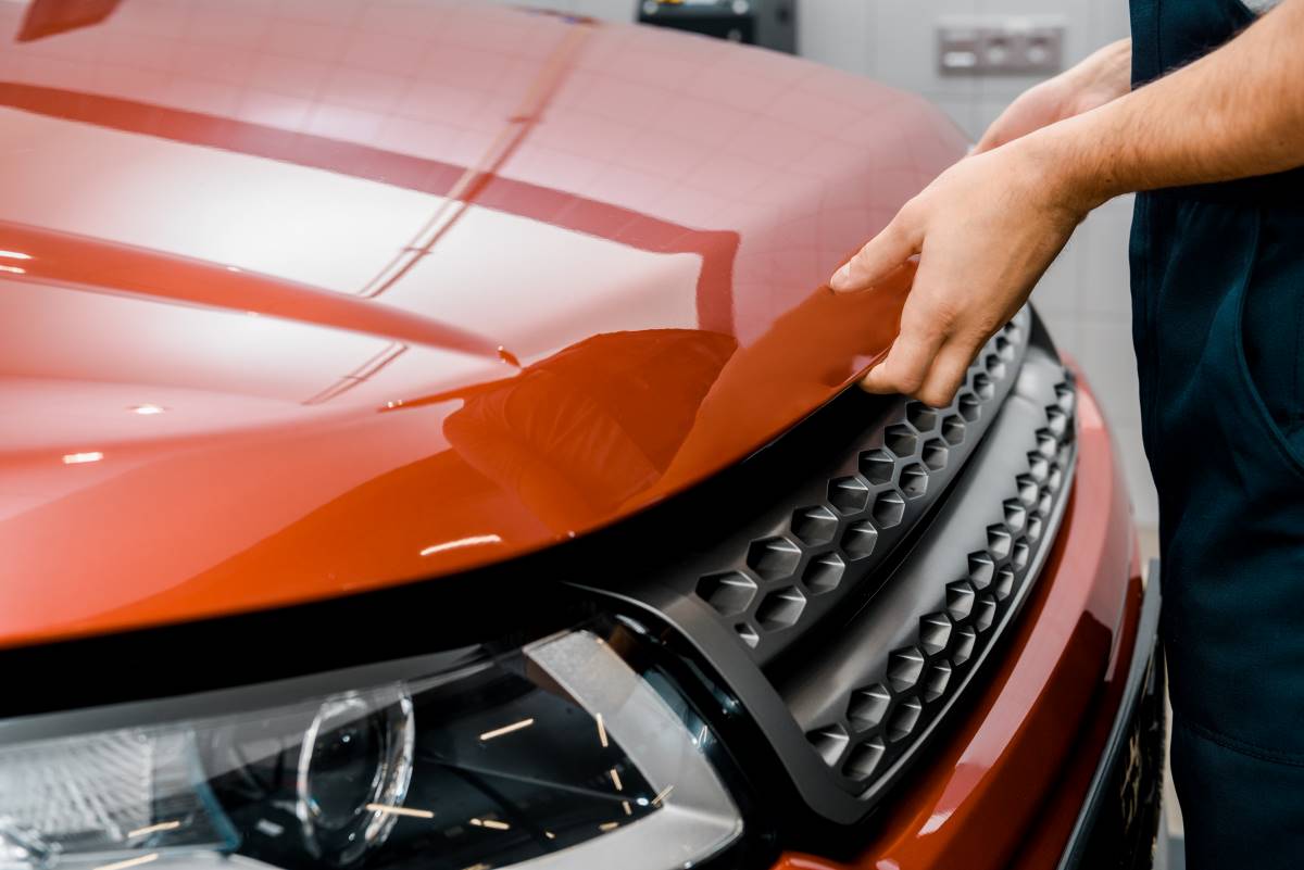 a car mechanic opening car bonnet