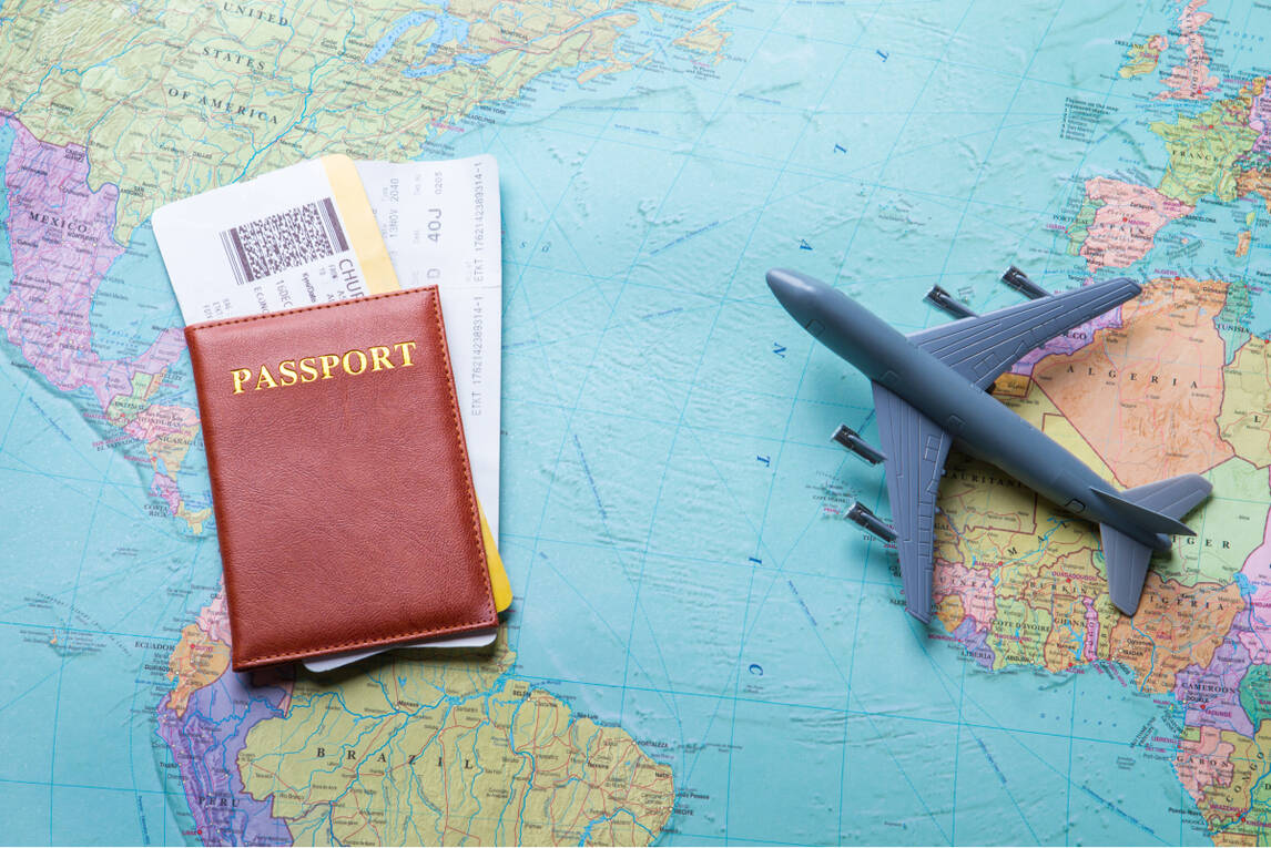 on the world map with aeroplane and passport