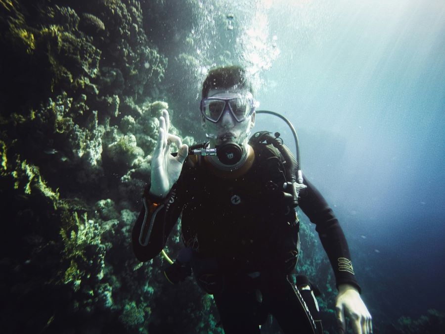 male scuba diver showing okay to camera