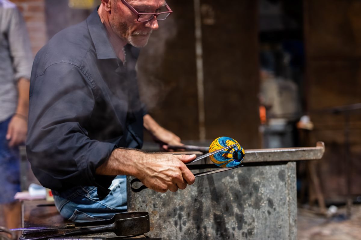 glass blower at work in workshop in murano