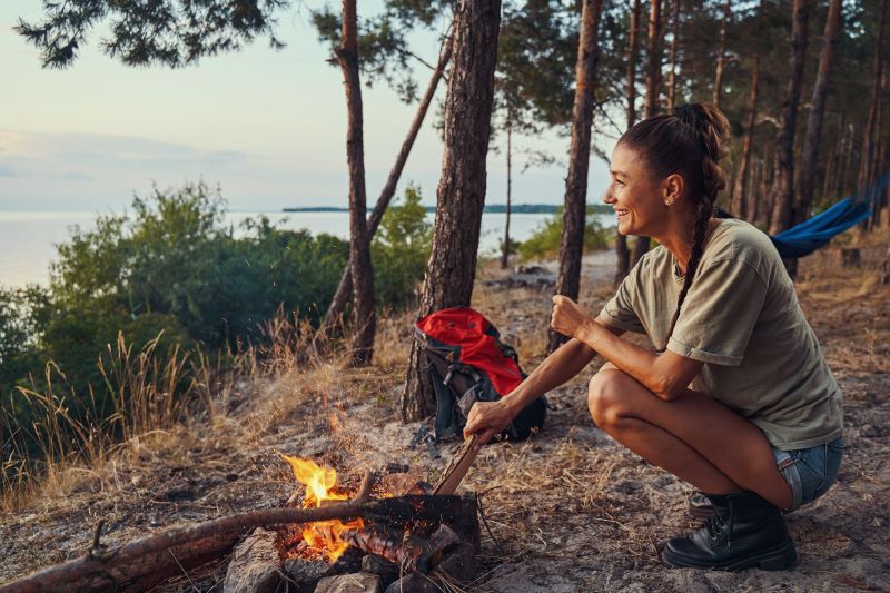 girl at mountain with bonfire