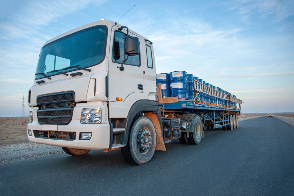 white heavy truck truck on empty road