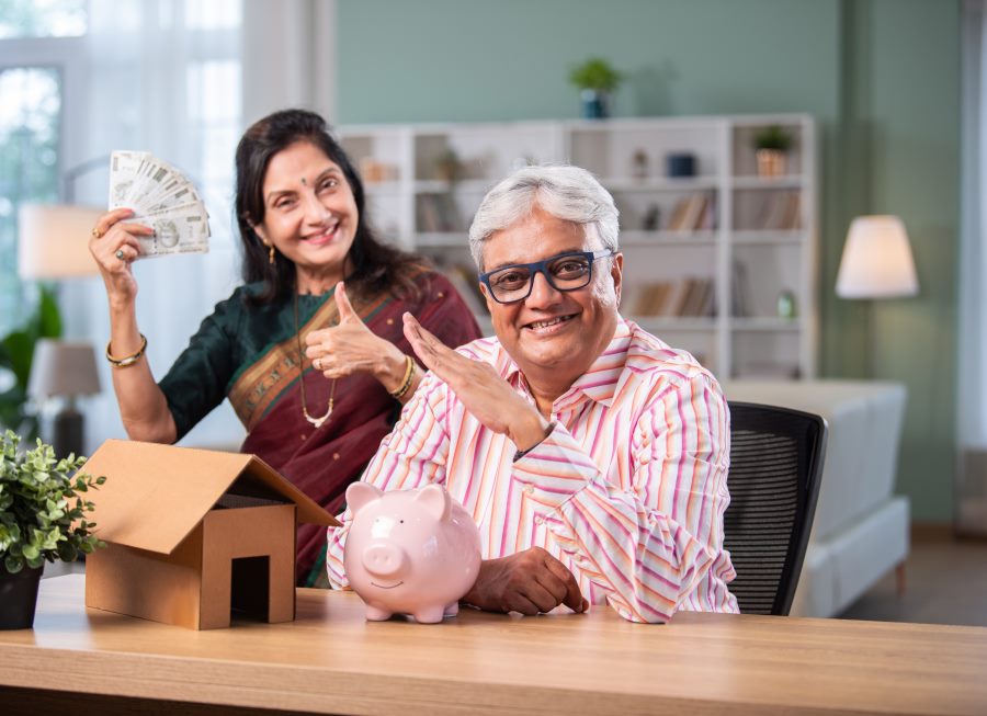 senior citizens holding money and calculating income tax