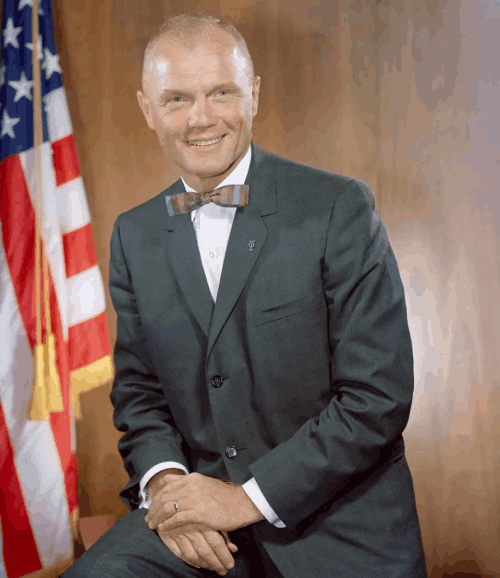 john glenn posing for camera wearing black suite