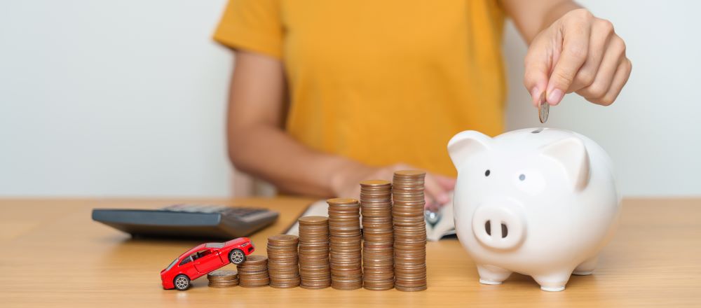 kid putting coin in pig tin