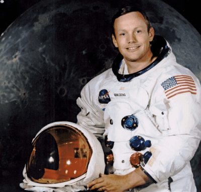 neil amstrong posing for camera in astronaut suite