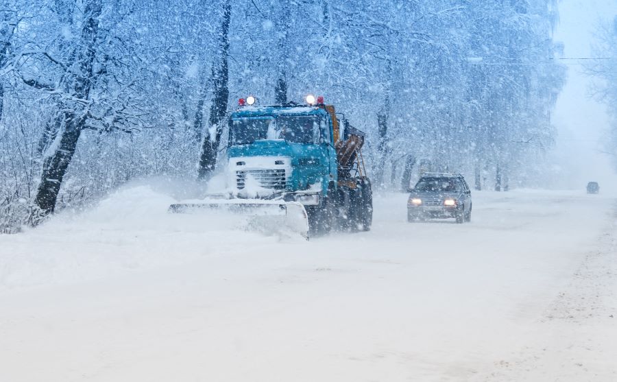 trucks removing snow from road