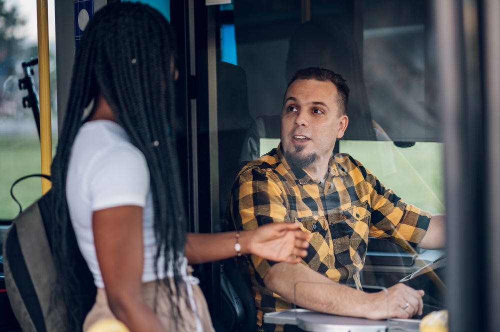bus driver talking to a girl