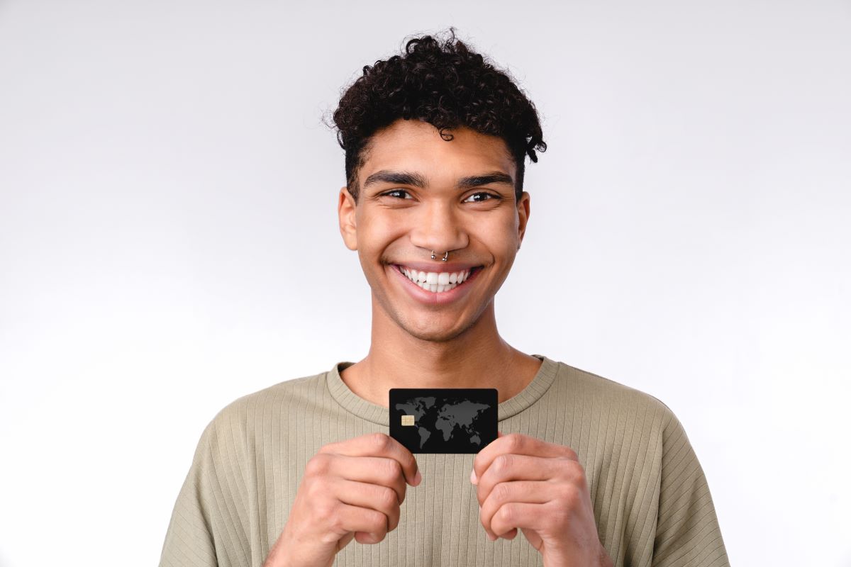 young african student holding credit card
