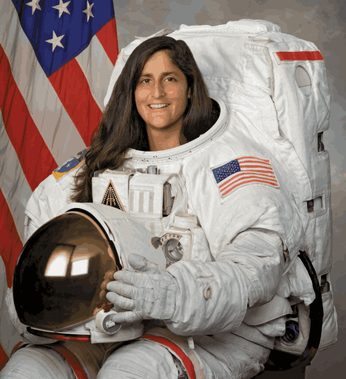 sunita williams with astronaut suit posing for camera