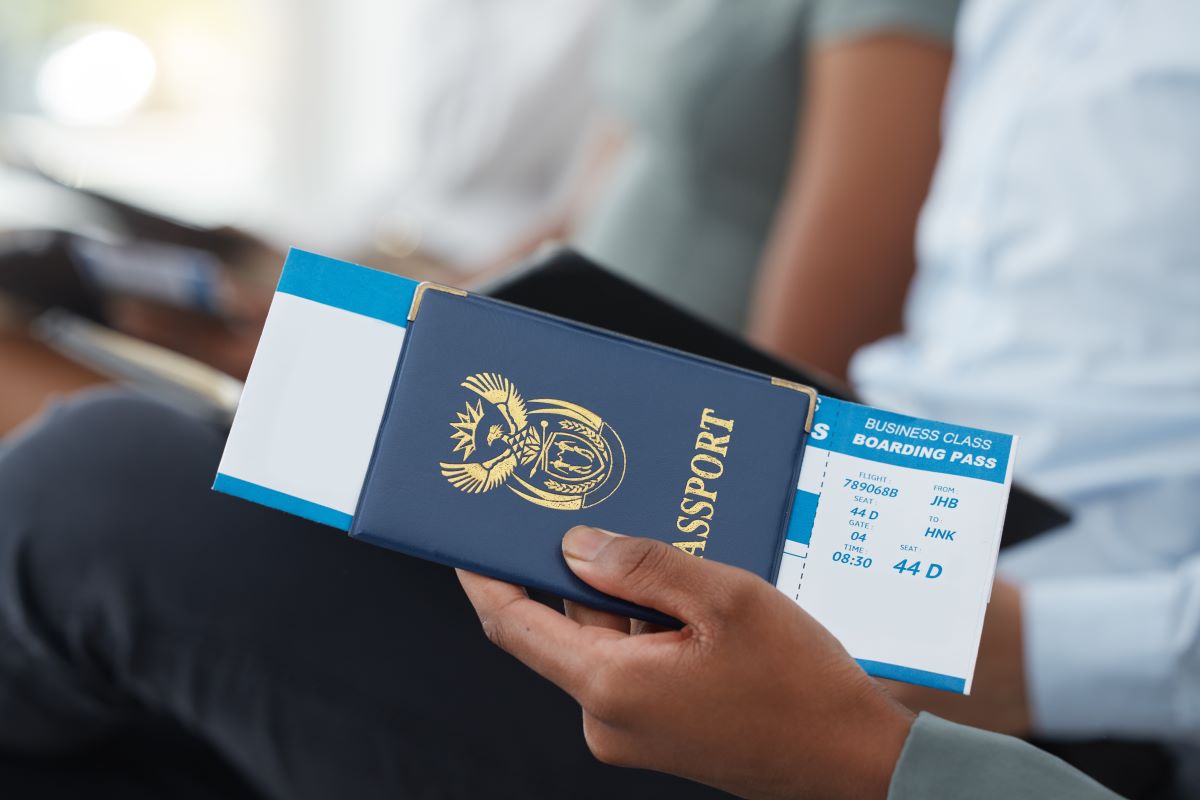 business man holding passport with business tickets