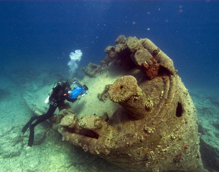 scuba diver capturing old wrecked ship