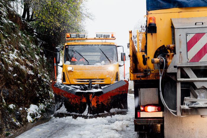 yellow truck carrying snow
