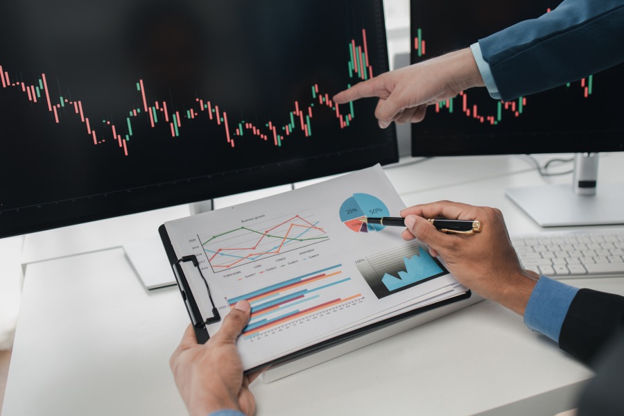 A business individuals analyzing the stocks using ROE and ROCE