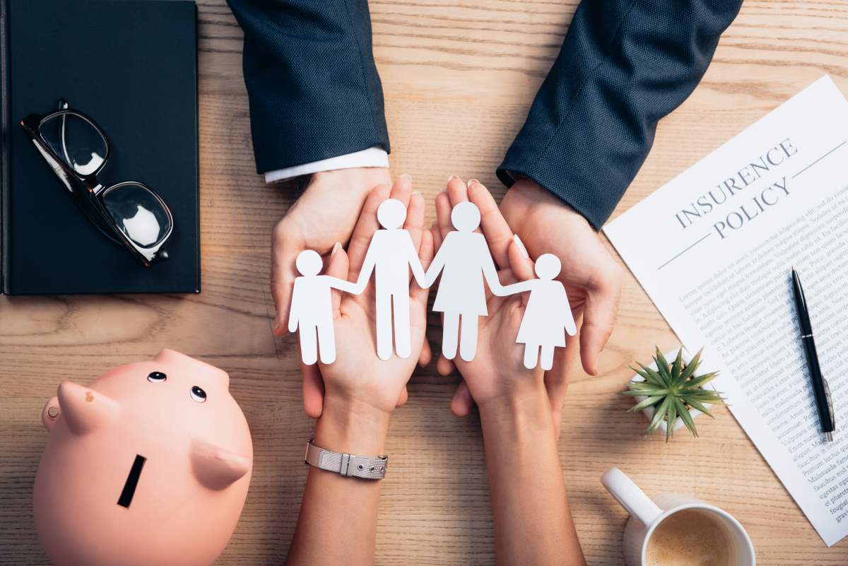 top view of lawyer and woman holding paper cut fam