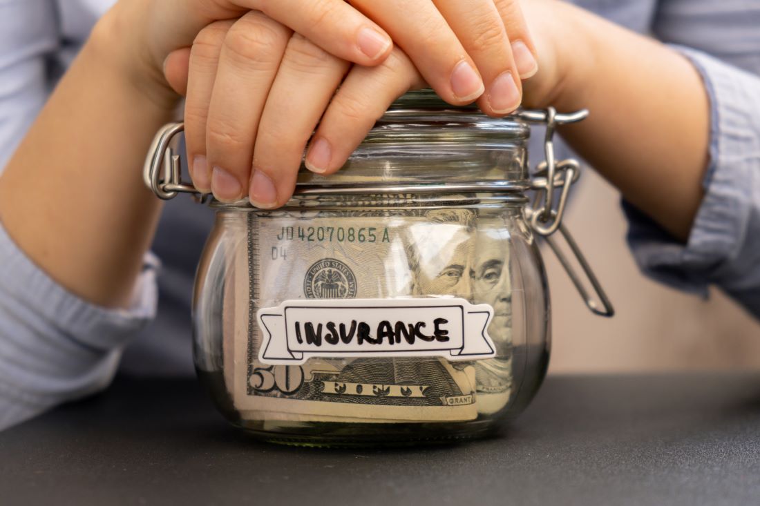 woman saving money in a glass